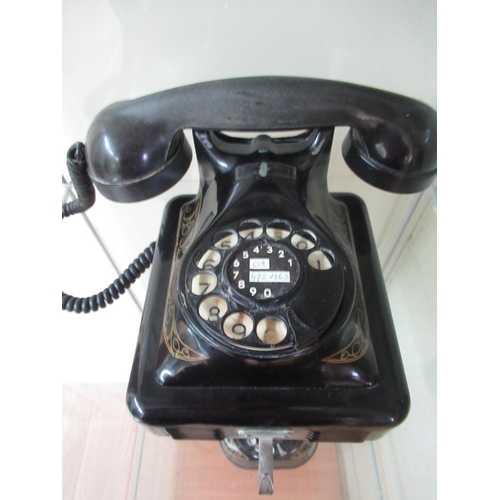 75 - Mid 1950s Bell Telephone Company telephone with painted black alloy body and gilt highlights and Bak... 