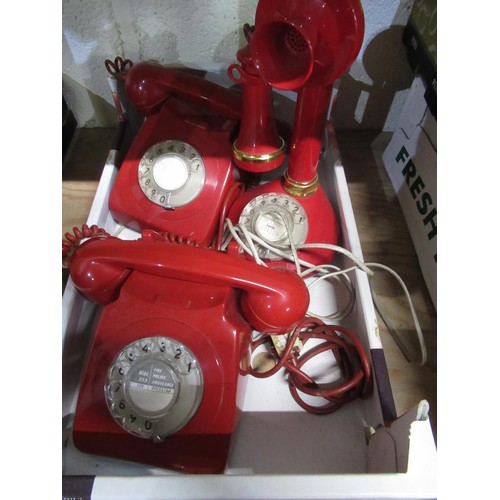 77 - Red candlestick type telephone and two other red dial telephones (3)