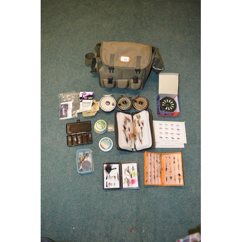 173 - Green canvas fishing bag with various fly fishing equipment, including reels, Rim fly, Intrepid, fou... 