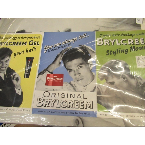 128 - Six Brylcreem hairdressing product adverts and a collection of aktionsgruppe haarschnitt male salon ... 