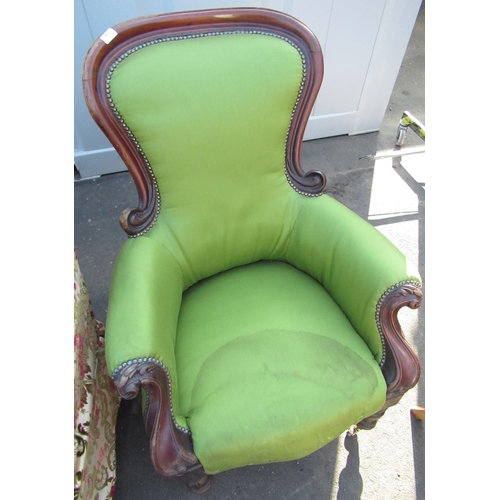 556 - Victorian mahogany framed armchair with elaborate carved detail on turned supports