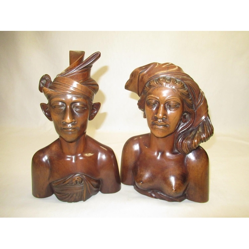 118 - C20th, pair of hardwood Polynesian busts of female and male figure H30 and H34 respectively