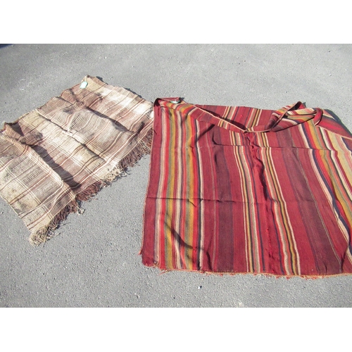 82 - South American poncho, red ground with striped panels W117cm L129cm and a C20th string woven rug W10... 