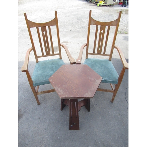 89 - Pair of early C20th Arts and Crafts golden oak elbow  chairs with pierced central splat scroll arms ... 