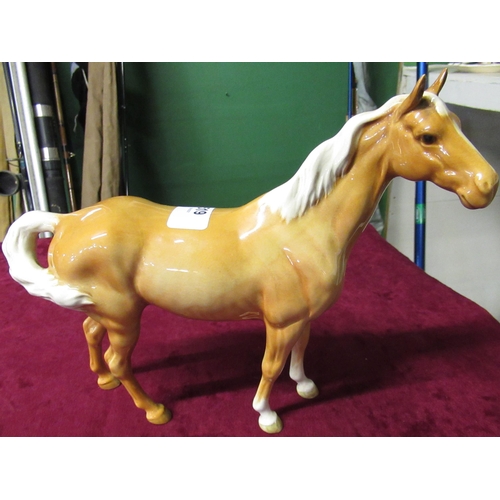 519 - Beswick model of a palomino pony with a swish tail H21.5cm