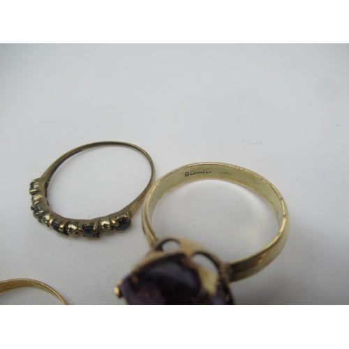 655 - Child's 9ct gold bangle, a 9ct gold solitaire ring with claw set purple stone and two other unmarked... 