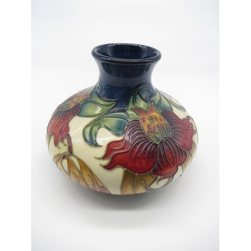 693 - Moorcroft potter vase, squat body decorated with foliage on a cream ground, impressed marks and pain... 
