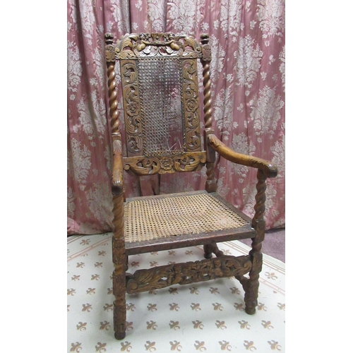 1436 - Carolean style walnut elbow chair, with cane work seat and back and cherub cresting, the barley twis... 