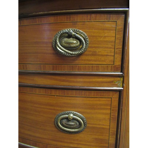 1446 - Edwardian Sheraton revival satinwood crossbanded bow front kneehole sideboard, the top inlaid with f... 