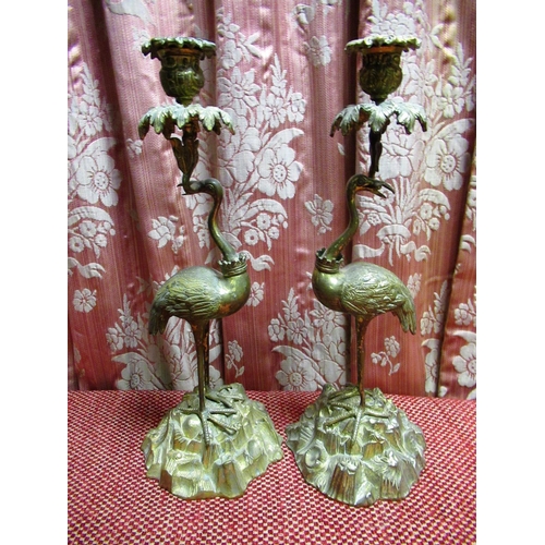 1470 - Pair of Victorian cast gilt metal candlesticks in the form of cranes supporting urn shaped and leaf ... 