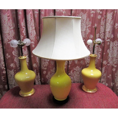 1387 - Pair of yellow glazed mallet shaped two light table lamps on gilt bases 50cm, and a yellow glazed ba... 