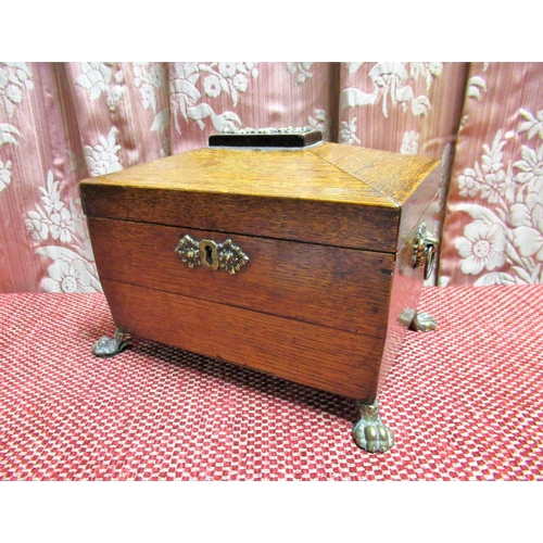 1050 - C19th oak sarcophagus shaped two division tea caddy, with brass cartouche, handle and paw feet, W21c... 
