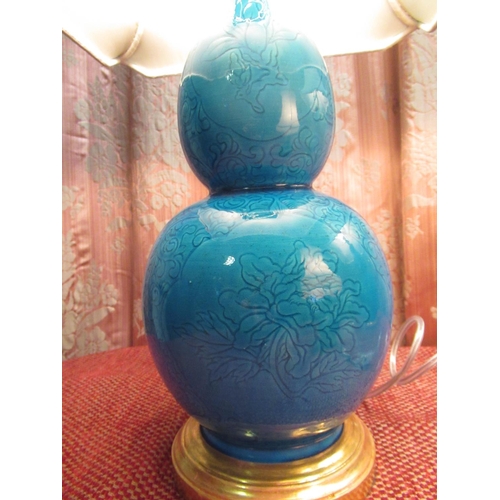 1016 - Pair of blue glazed gourd shaped table lamps, with incised floral and leafage decoration, stepped ci... 