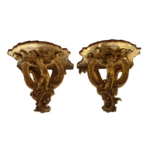 1479 - Pair of Italian Rococo revival giltwood wall brackets, shaped plateau on C scroll and cherub carved ... 