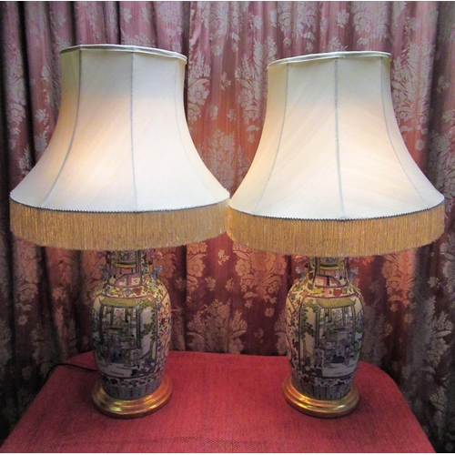 1007 - Pair of large Canton baluster shaped table lamps decorated in Famile enamels, on circular wood bases... 