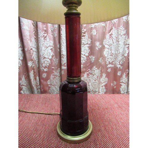 1395 - Victorian style red table lamp of stepped faceted form, on circular stepped brass base, with shade, ... 