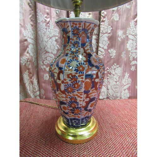 1389 - Japanese Imari table lamp, the fluted baluster body all-over decorated with profuse foliage, on step... 