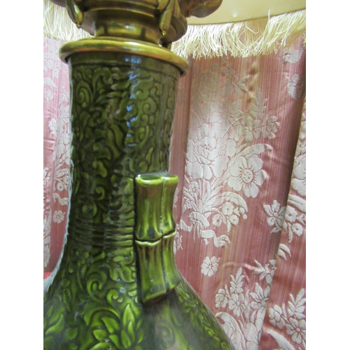 1384 - Chinese style table lamp, the green glazed bottle shaped body relief decorated with flowers with two... 