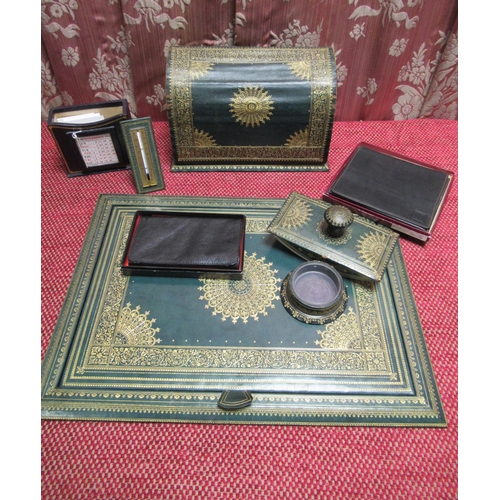 1057 - Early C20th gilt tooled green leather desk set comprising rectangular writing pad with reversible bl... 