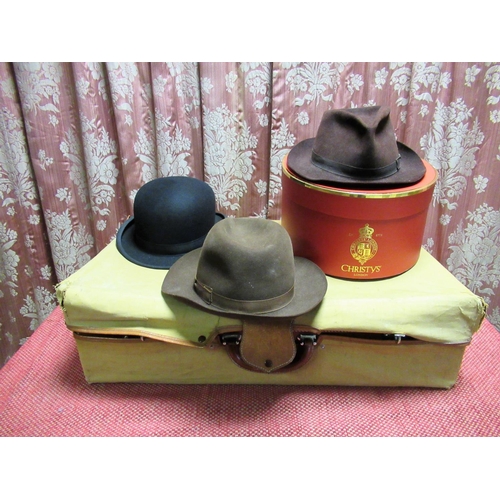 1489 - Two Christys' of London brown felt trilby hats, both 7 1/8, a Dunn & Co. of London long oval bowler ... 