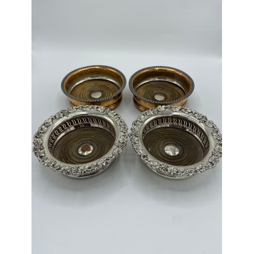 1005 - Pair of C19th silver plated wine coasters with vine cast borders, a similar pair of silver plate on ... 