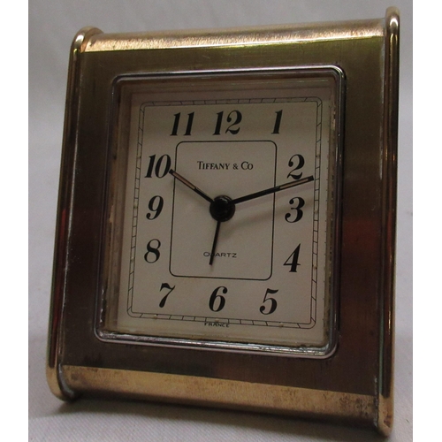 775 - WITHDRAWN - Tiffany & Co quartz alarm clock, lacquered brass strut case, champagne coloured dial set... 