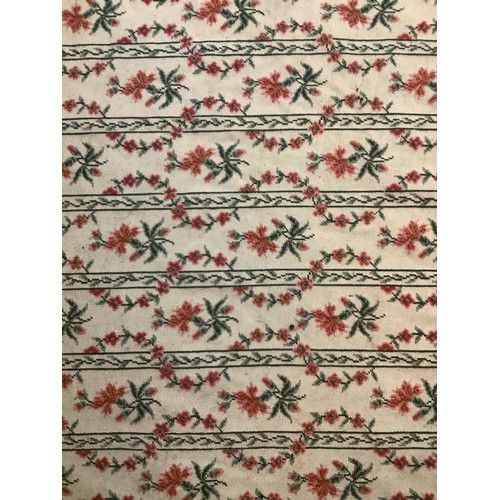 1375 - Woolwork rectangular rug worked with floral stripes on a cream ground in a green border, 177cm x 274... 