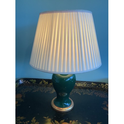 1226 - Pair of green glazed baluster shaped table lamps on gilt bases, pleated ivory shades, H57cm