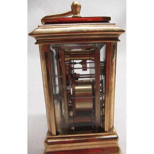 51A - C20th miniature lacquered brass carriage clock with white enamel dial and subsidiary dials for day a... 