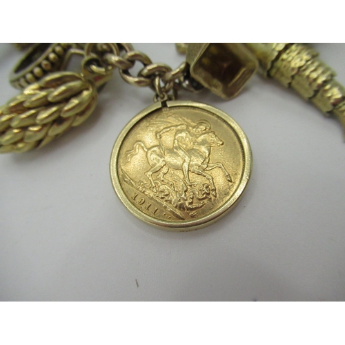 522 - 9ct gold charm bracelet with Victorian and later charms including Geo V, sovereign and half sovereig... 