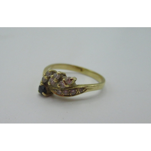 532 - 18ct gold ring with sapphire and white stones set in petal shaped mounts size K 1/2 2.3g