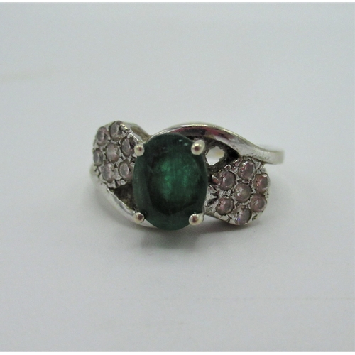 537 - Platinum ring with central emerald flanked by rosettes set with seven diamonds stamped 85 Size N gro... 