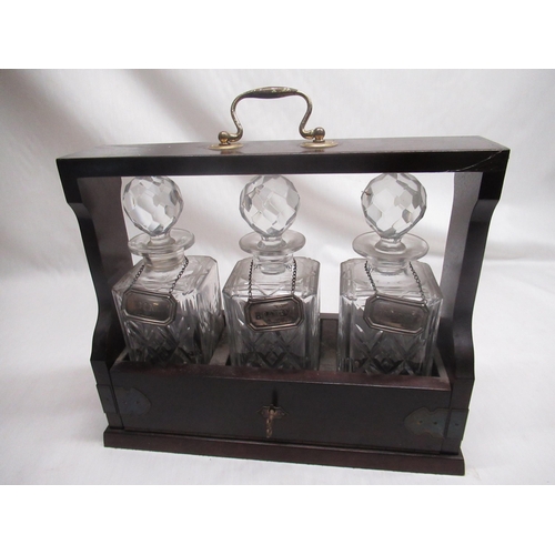 551 - C20th 3 bottle mahogany tantalus with silver 