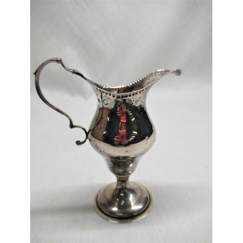 586 - ER.II silver Georgian style cream jug with scroll handle on circular stepped foot, London 1970