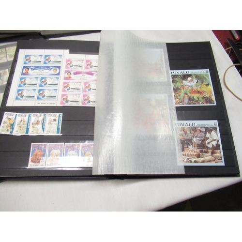 78 - Six stamp albums relating to Tuvalu