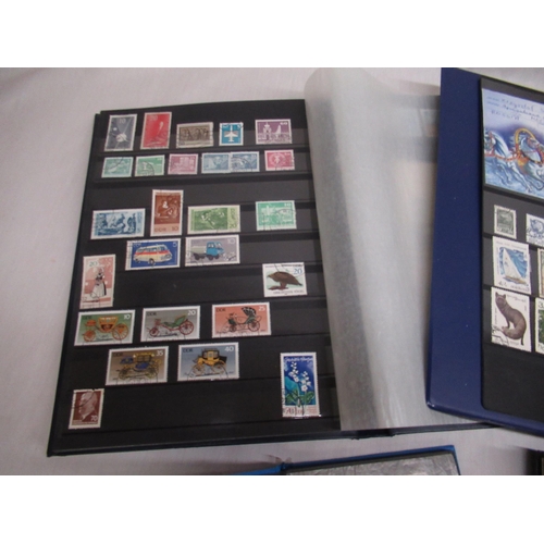 80 - Four stamp albums relating to Russia, Soviet Union, DDR, and the SAAR Protectorate