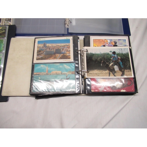 95 - Four albums of cigarette cards postcards coins etc