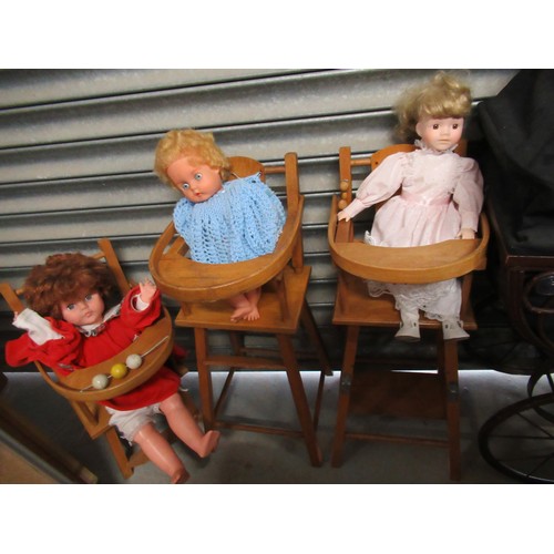 63 - Three light wood dolls highchairs and a selection of dolls