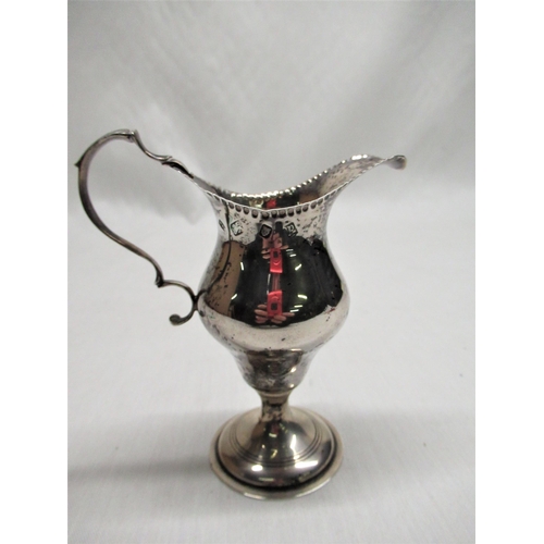104 - ER.II silver hallmarked Georgian style cream jug with scroll handle on circular stepped foot, London... 
