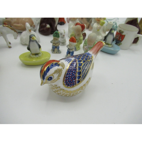 184 - Royal Crown Derby bird paperweight, gold capped, and a collection of small figures