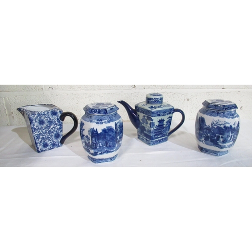 508 - Ringtons tea pot in blue and white willow pattern design, two lidded blue and white jars in cathedra... 