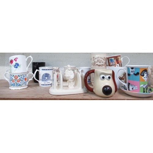 528 - Collection of various cups and mugs including Ringtons bunny mugs, Liquorish All Sorts mug, money bo... 