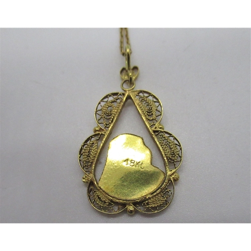 79 - 18ct yellow gold religious pendant in filigree tear drop mount L3cm on a chain with spring ring clas... 