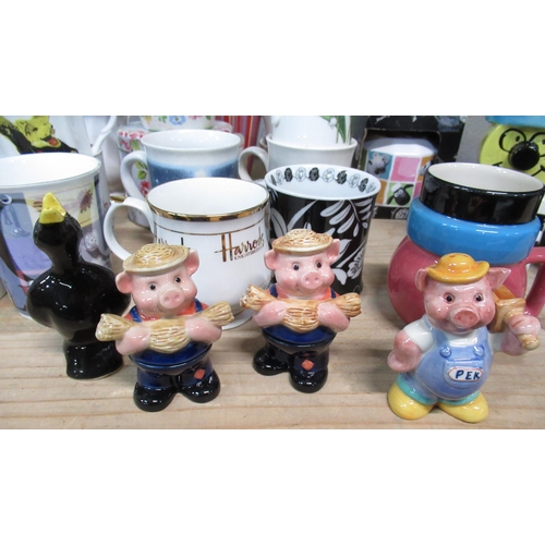 528 - Collection of various cups and mugs including Ringtons bunny mugs, Liquorish All Sorts mug, money bo... 