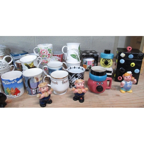 528 - Collection of various cups and mugs including Ringtons bunny mugs, Liquorish All Sorts mug, money bo... 