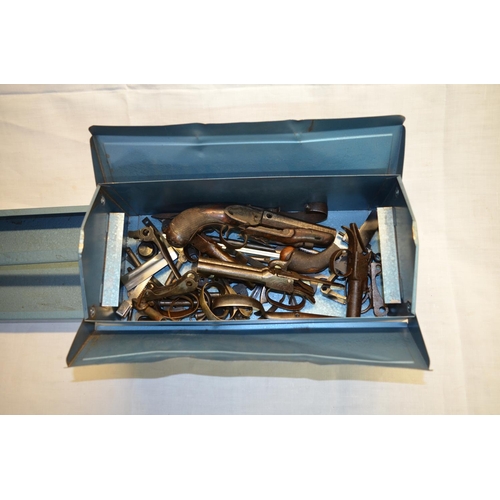 59 - Metal toolbox containing a quantity of various antique gun parts, including parts of a percussion ca... 
