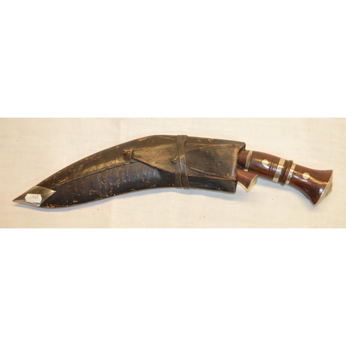 74 - Kukri in leather sheath with rosewood handles and two smaller knives (3)