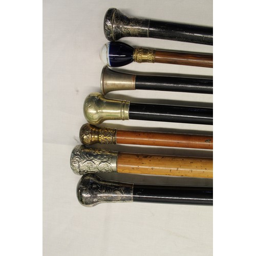 149 - Collection of seven metal topped walking canes with various woods including ebony, bamboo, etc