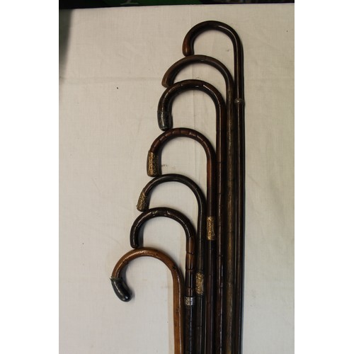 152 - Set of seven walking canes four with metal mounted handles and metal collars