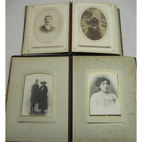 114 - Two Victorian leather bound photograph albums containing cabinet card family portrait photographs (2... 